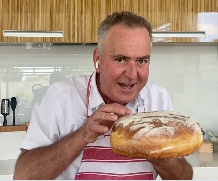 Simon Gault holding a large cob loaf ready to create the CREAMY CORN AND TOMATO COB LOAF dip