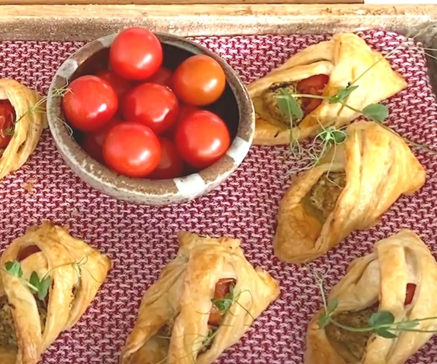Cooked tomato and cheese savouries with a bowl of fresh cherry tomatoes